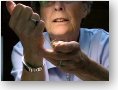 Mary Dette applying varnish to the head of a fly with a syringe